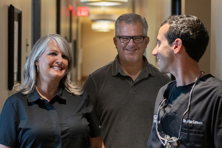 Couple consulting with doctor